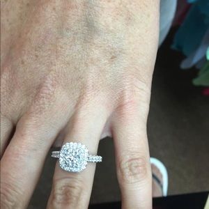 Halo engagement ring with round center stone.